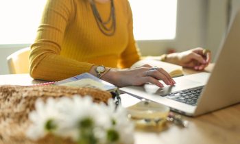 A woman working from her home office on a laptop.