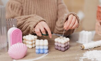 Closeup of a woman creating handmade candles to make and sell from home.