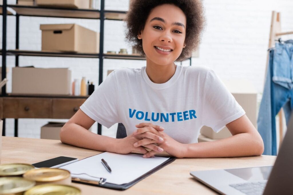 A woman volunteering remotely from a laptop in her home office.