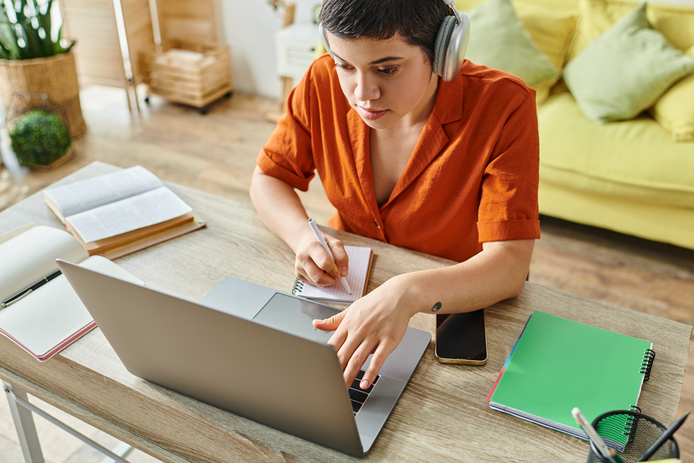 Attractive short haired woman with headphones doing transcription work from CrowdSurf