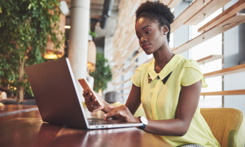 Young woman searching for work from home jobs in Texas on her laptop