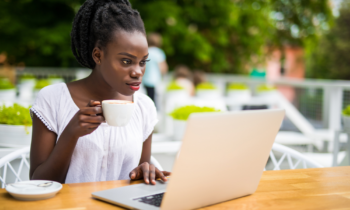 Black woman drinking coffee participating in a paid focus group online