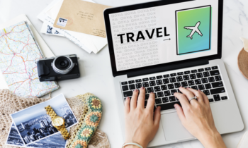 Cruise Planners Franchise Review woman on laptop booking travel