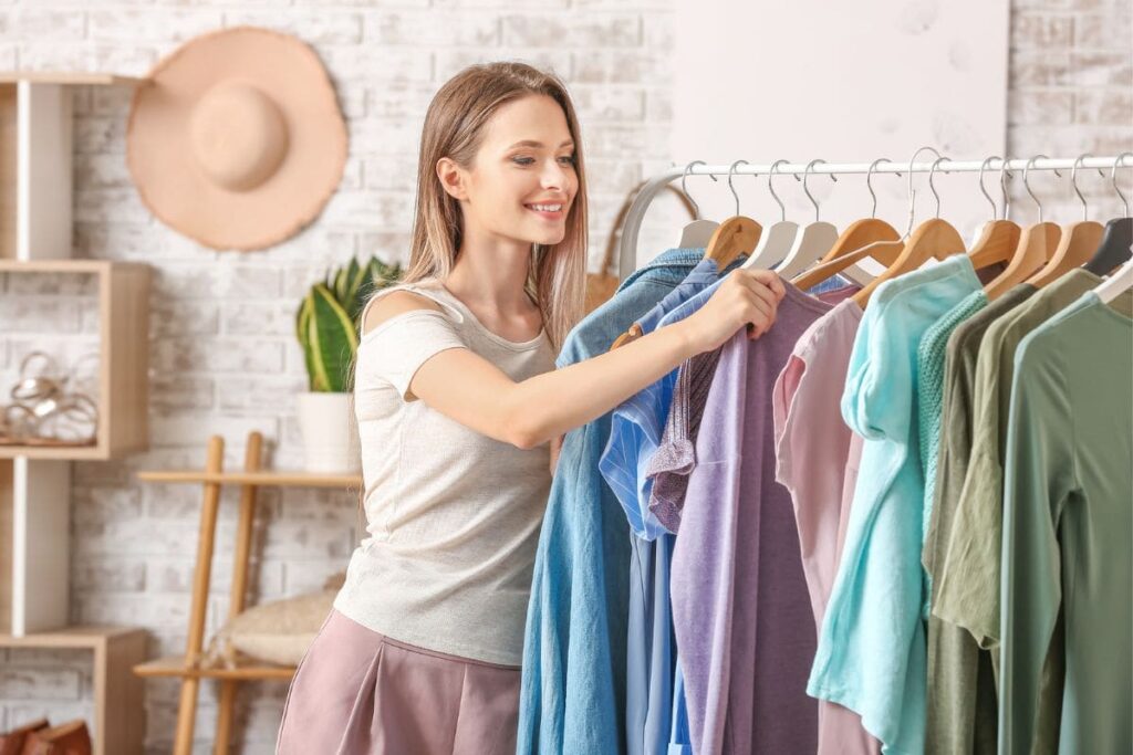 A woman looking through clothing items on a rack.