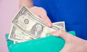 Image of woman holding wallet with cash - How to Make $30 in 30 Minutes or Less