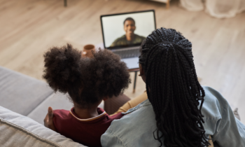 Military spouse and daughter having a video call with their loved one