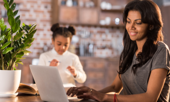 Mom working from home at kitchen table during school hours