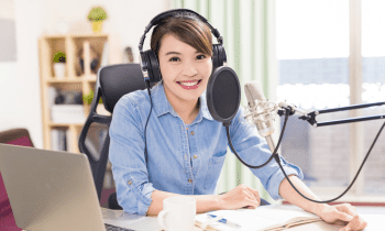 young woman in her home studio recording a voice demo