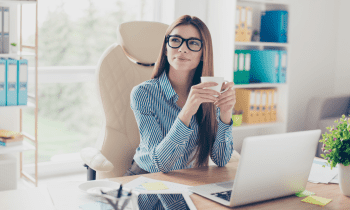 Women working at her desk drinking coffee