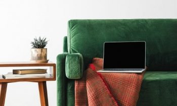 Laptop sitting on sofa in stylish living room.