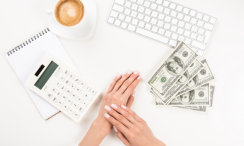 Woman counting her money from her side gig where she makes an extra $100 per week