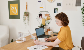 Young woman working from home reviewing documents for Amazon